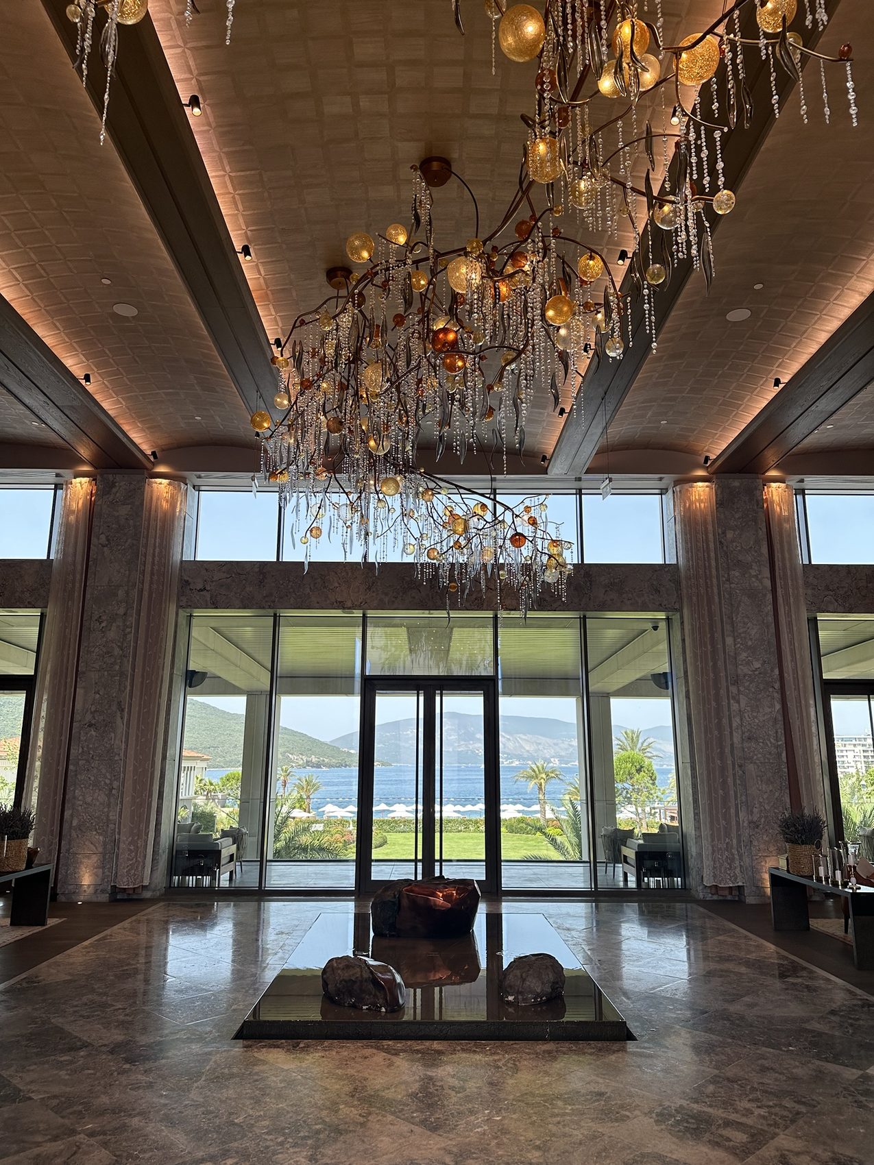The lobby at One&Only Portonovi, with the bay through the glass.